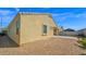 Exterior view of the backyard with brick patio, desert landscaping, and covered patio at 2296 S 235Th Dr, Buckeye, AZ 85326