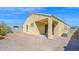 Exterior view of the backyard with brick patio, desert landscaping, and covered patio at 2296 S 235Th Dr, Buckeye, AZ 85326