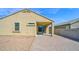 Exterior view of the backyard with brick patio, desert landscaping, and covered patio at 2296 S 235Th Dr, Buckeye, AZ 85326