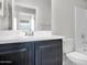 Bathroom featuring dark vanity cabinets and tiled shower at 2296 S 235Th Dr, Buckeye, AZ 85326