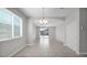 Open dining room with a modern chandelier and sliding glass doors to the backyard at 2296 S 235Th Dr, Buckeye, AZ 85326
