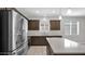 Modern kitchen featuring stainless steel appliances, a center island, and ample cabinet space at 2296 S 235Th Dr, Buckeye, AZ 85326