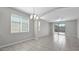 Open-concept living room featuring tile floors, natural light, and access to the outdoor patio at 2296 S 235Th Dr, Buckeye, AZ 85326
