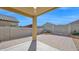 This covered patio features a beautiful brick-paved area and views of the backyard at 2296 S 235Th Dr, Buckeye, AZ 85326