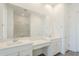 Bathroom featuring double sinks, white cabinetry, and a glass shower at 23146 E Nightingale Rd, Queen Creek, AZ 85142