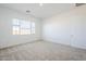 Sun-filled bedroom with a large window and neutral carpet at 23146 E Nightingale Rd, Queen Creek, AZ 85142