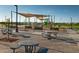 Inviting community park featuring playground equipment, picnic tables and shaded seating areas at 23146 E Nightingale Rd, Queen Creek, AZ 85142