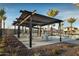 Inviting covered ramada in community pool area with picnic tables and lounge chairs at 23146 E Nightingale Rd, Queen Creek, AZ 85142