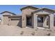 Charming single-story home with brick accents, a two-car garage, and inviting front porch at 23146 E Nightingale Rd, Queen Creek, AZ 85142