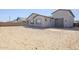 Home exterior featuring desert landscaping and a three car garage at 23146 E Nightingale Rd, Queen Creek, AZ 85142