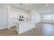 Bright, open kitchen with white cabinets, quartz countertops, and stainless steel appliances at 23146 E Nightingale Rd, Queen Creek, AZ 85142