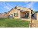 The house features a well-maintained lawn and a cozy, covered patio that enhances the backyard appeal at 2521 W Mark Ln, Phoenix, AZ 85085