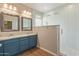 Updated bathroom with a double sink vanity and a glass-enclosed shower at 2521 W Mark Ln, Phoenix, AZ 85085