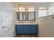Bathroom with a blue double sink vanity, framed mirrors, and updated shower at 2521 W Mark Ln, Phoenix, AZ 85085