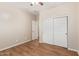 Bedroom with wood-style flooring, ceiling fan, and a sliding door closet at 2521 W Mark Ln, Phoenix, AZ 85085