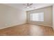 Bright bedroom with a ceiling fan, natural light, and wood-style floors at 2521 W Mark Ln, Phoenix, AZ 85085