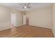 A spacious bedroom with natural light and wood-style flooring at 2521 W Mark Ln, Phoenix, AZ 85085