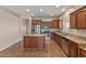 Modern kitchen featuring stainless steel appliances, granite countertops, and wood-look tile flooring at 2521 W Mark Ln, Phoenix, AZ 85085
