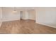 Open-concept living room with wood-look tile floors, neutral walls, and ample space for entertaining at 2521 W Mark Ln, Phoenix, AZ 85085