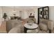 Open-concept room with hardwood floors, neutral colors, and stylish furniture for an elegant feel at 2521 W Mark Ln, Phoenix, AZ 85085