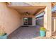 Spacious covered patio with brick flooring, a ceiling fan, and lush landscaping at 2521 W Mark Ln, Phoenix, AZ 85085