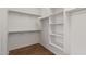 Walk-in closet with built-in shelving and hanging rods for storage at 2521 W Mark Ln, Phoenix, AZ 85085