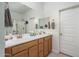 Bathroom with a double sink vanity, large mirror, and a separate shower room at 25330 N 134Th Dr, Peoria, AZ 85383