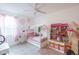 Adorable bedroom featuring a cozy bed frame, ceiling fan, and cheerful pink accents at 25330 N 134Th Dr, Peoria, AZ 85383