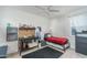 Bedroom with a ceiling fan, modern decor, a small bed, and a work area at 25330 N 134Th Dr, Peoria, AZ 85383