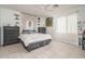 Bright bedroom featuring tile flooring, ceiling fan, lots of decor, and curtains allowing natural light at 25330 N 134Th Dr, Peoria, AZ 85383