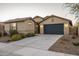 Charming single-story home featuring a two-car garage, desert landscaping, and a neutral color palette at 25330 N 134Th Dr, Peoria, AZ 85383