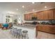 Bright kitchen with stainless steel appliances, granite countertops, large island with seating, and view of dining area at 25330 N 134Th Dr, Peoria, AZ 85383