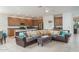 Open-concept living room featuring tile flooring, kitchen with stainless steel appliances, and a modern ceiling fan at 25330 N 134Th Dr, Peoria, AZ 85383