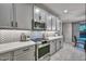 Stylish kitchen featuring gray cabinetry, stainless steel appliances, and quartz countertops at 25756 N 140Th Ln, Surprise, AZ 85387