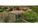Aerial view of the elegant home surrounded by mature trees and lush green landscaping at 2799 E Jade Pl, Chandler, AZ 85286