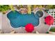 Aerial view of backyard pool, spa, rock feature and red umbrellas with string lights at 2799 E Jade Pl, Chandler, AZ 85286