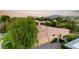 An aerial view of this home features its tile roof, manicured landscaping, and mountain backdrop at 2799 E Jade Pl, Chandler, AZ 85286