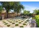 Large backyard patio area with travertine flooring, built in grill, and outdoor fireplace at 2799 E Jade Pl, Chandler, AZ 85286