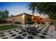 Wide angle view of covered patio with travertine tile, outdoor fire pit, and view of pool at 2799 E Jade Pl, Chandler, AZ 85286