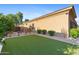 Expansive backyard featuring lush artificial turf, manicured landscaping, and a serene outdoor ambiance at 2799 E Jade Pl, Chandler, AZ 85286