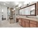 Modern bathroom features a glass-enclosed shower, vanity, and stone countertops, blending luxury and comfort at 2799 E Jade Pl, Chandler, AZ 85286