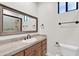 Bathroom featuring a single sink, tile countertop, and decorative framed mirror at 2799 E Jade Pl, Chandler, AZ 85286