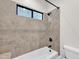 Modern bathroom with tub and shower combo featuring a rain shower head and a window at 2799 E Jade Pl, Chandler, AZ 85286