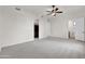 Bedroom with neutral carpet, ceiling fan, and open doorway to walk in closet at 2799 E Jade Pl, Chandler, AZ 85286