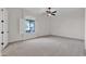 Spacious bedroom with neutral carpet, ceiling fan, and bright window with shutters at 2799 E Jade Pl, Chandler, AZ 85286