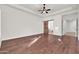 Spacious bedroom with hardwood flooring, a modern ceiling fan, and a barn door leading to the en-suite bathroom at 2799 E Jade Pl, Chandler, AZ 85286