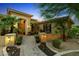 Elegant front entrance with decorative archway, lush landscaping, and a brick walkway at 2799 E Jade Pl, Chandler, AZ 85286