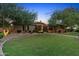 Well-maintained home with a lush green lawn and mature trees at dusk at 2799 E Jade Pl, Chandler, AZ 85286