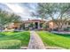 Charming one-story home featuring a tile roof, manicured lawn, and a decorative stone walkway at 2799 E Jade Pl, Chandler, AZ 85286