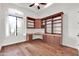 Well-lit home office featuring custom built-ins, a built-in desk, and a bright window at 2799 E Jade Pl, Chandler, AZ 85286